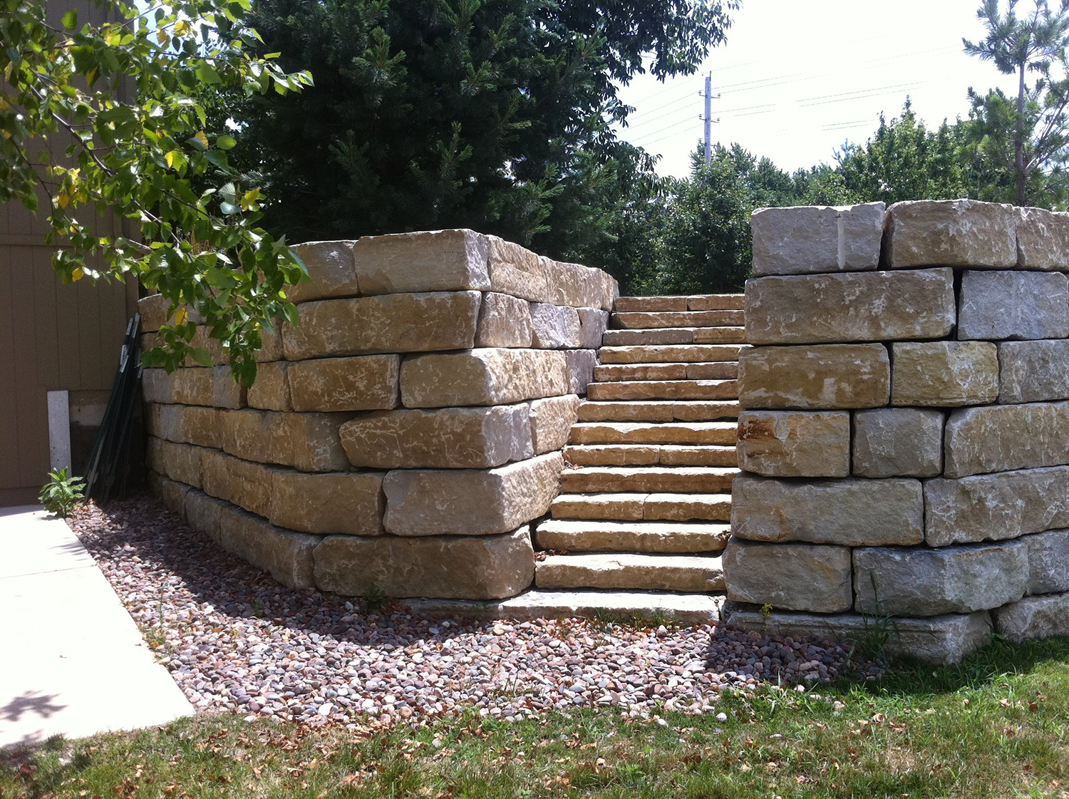 stone retaining wall with stairs built by Gradex