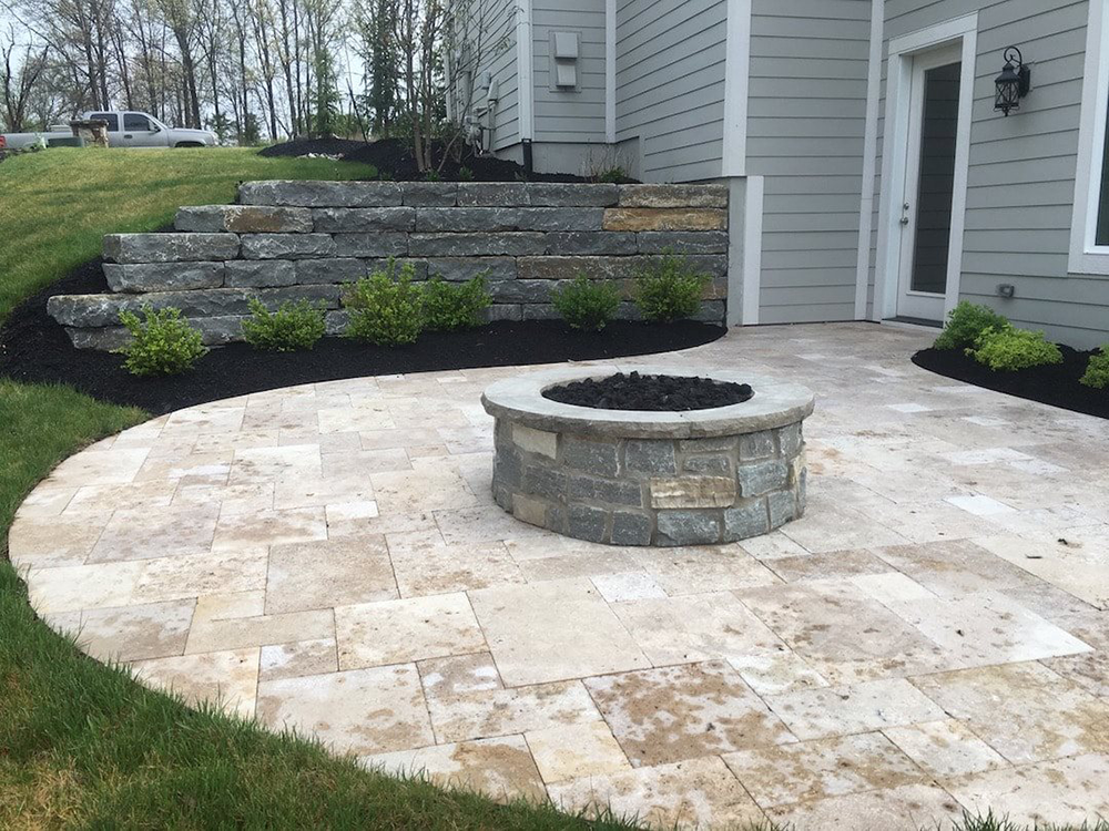 stone patio with built in fire pit by Gradex