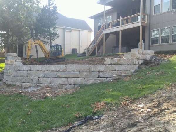 Limestone wall for a pool yet to be installed with a Infiniti edge lowered patio