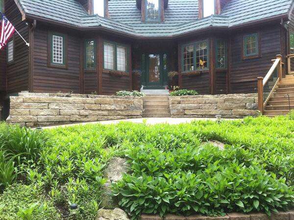 Stone retaining walls create small natural areas by the front door