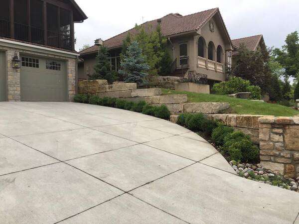 Tiered retaining wall edging a driveway