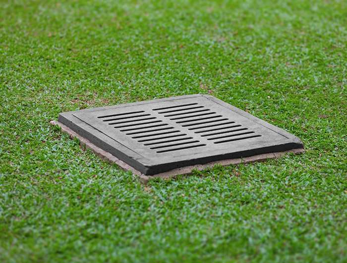 Large drainage grate in backyard