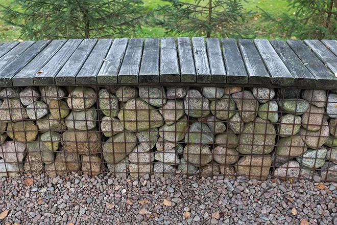 Gabion retaining wall doubling as a garden bench
