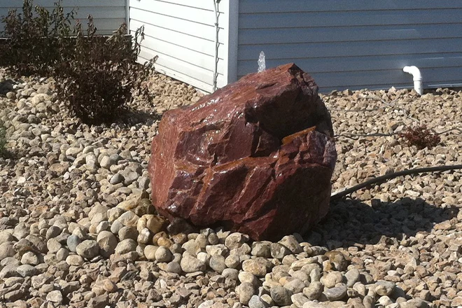 Large red-brown natural rock fountain