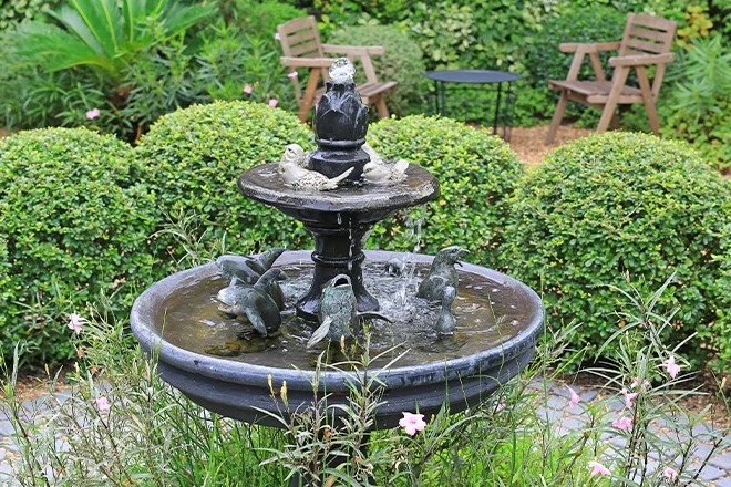 Tiered fountain with small statues in it